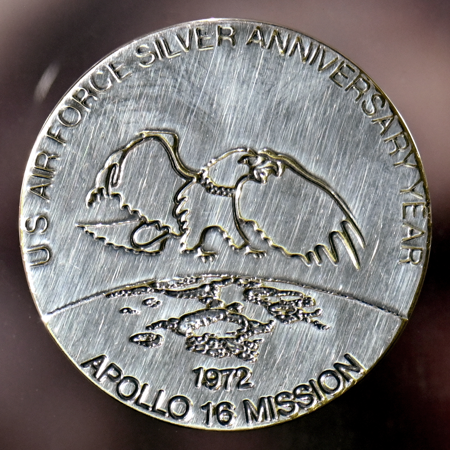 This commemorative medallion was taken to the moon by U.S. Air Force Colonel Charles M. Duke, Jr., Lunar Module Pilot for the Apollo 16 mission. A second, duplicate coin was left at the Descartes moon site by Duke in commemoration of the Silver Anniversary of the Air Force. The medallion, a moon rock and a flag were presented to the Air Force on July 13, 1972 by Duke. (Ty Greenlees/Air Force)