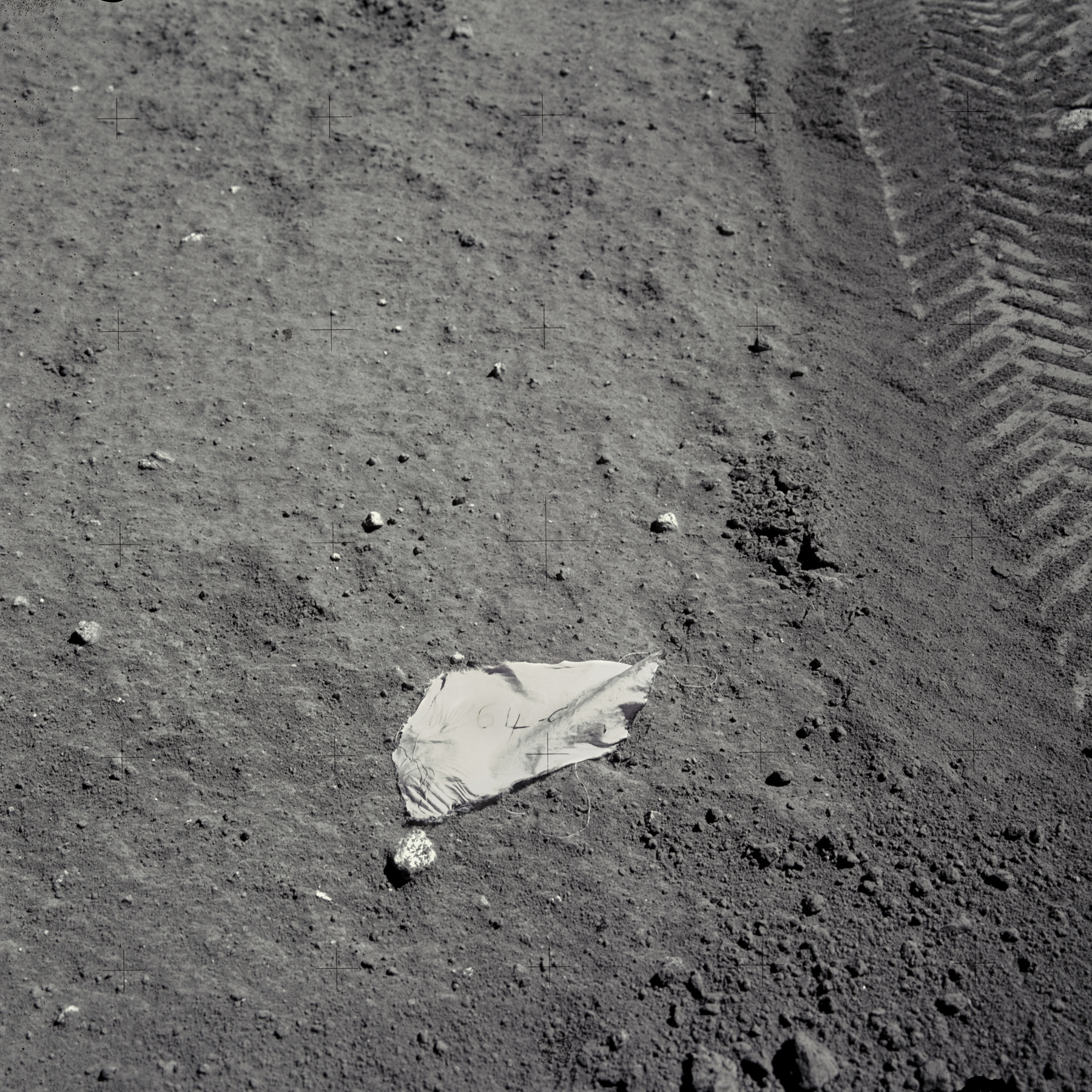 An image of a piece of spacesuit material with "64-C" written on it in honor of Apollo 16 astronaut Charlie Duke's class at the Air Force test pilot school. (NASA/Johnson Space Center/Arizona State University/Andy Saunders)